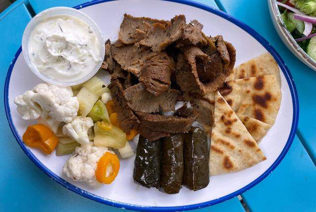 Ilios Crafted Greek’s lamb with grape leaves, vegetables and a side of tzatziki.